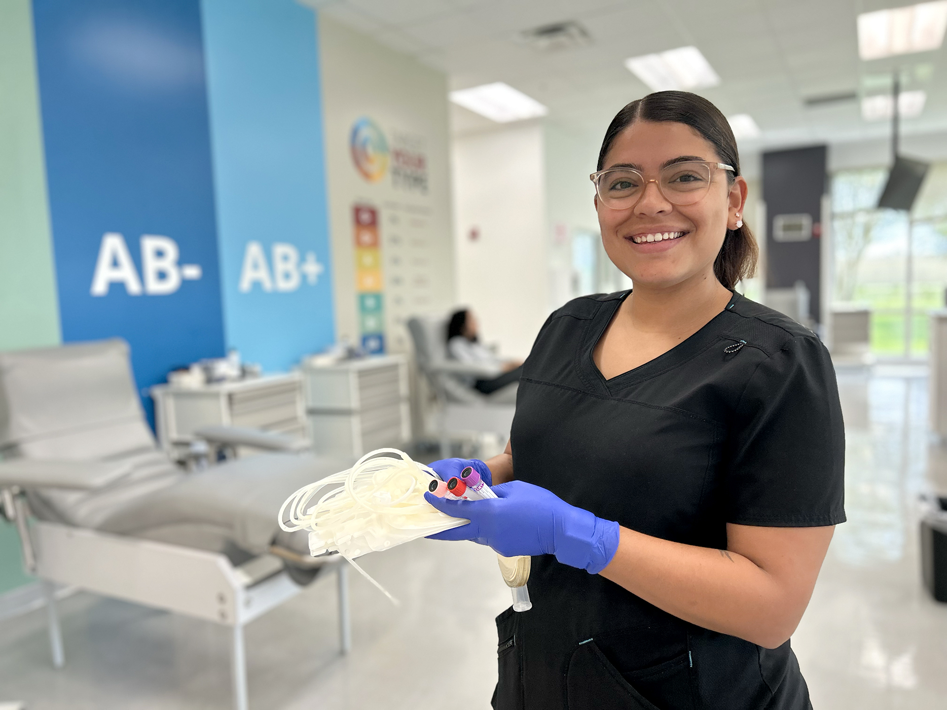 Phlebotmist holding a unit of blood at a donor center