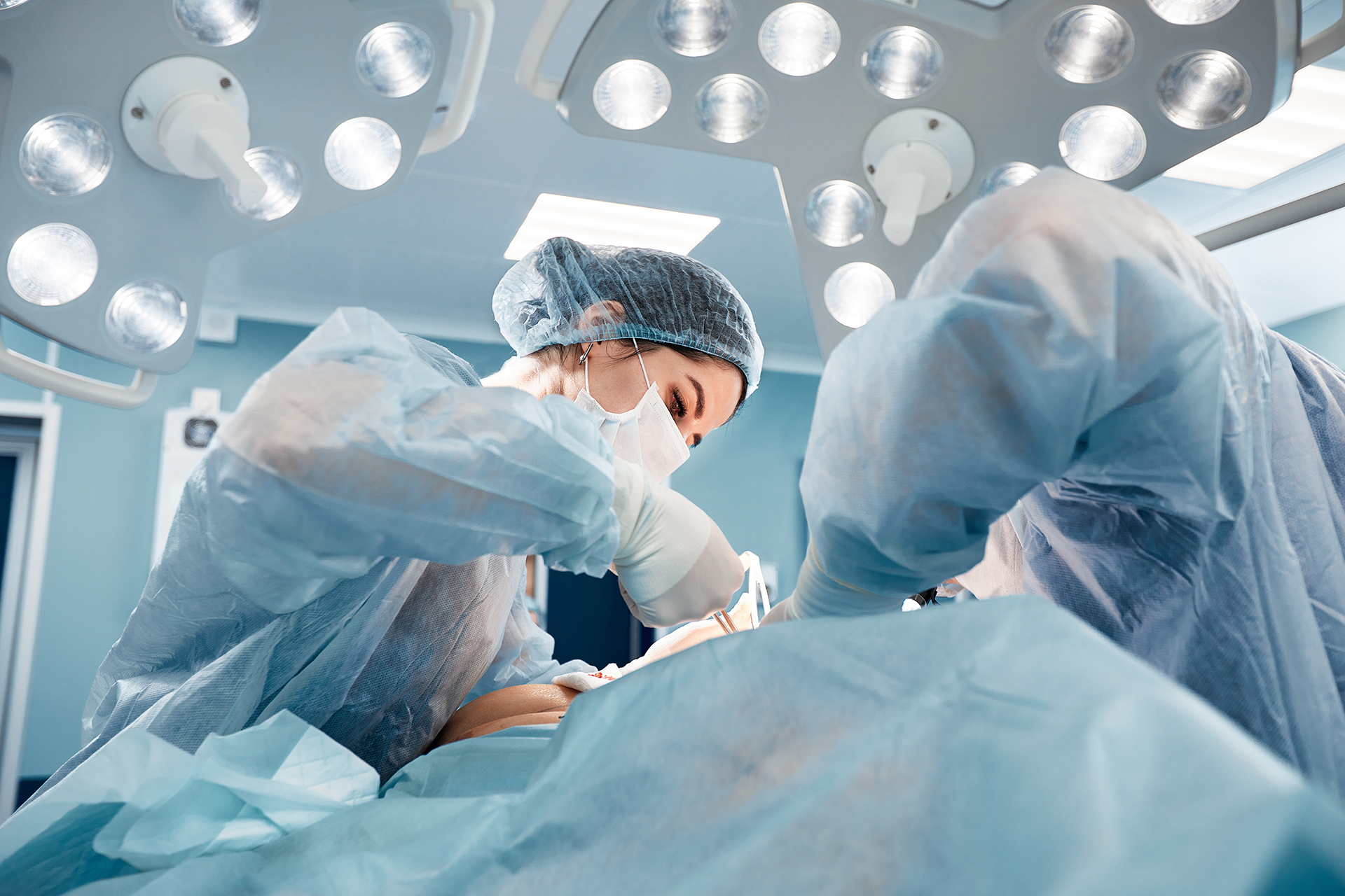 Surgeons in the operating room with face covering